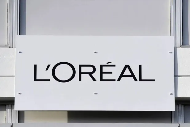 This photo taken on February 16, 2018 shows a board with the L'Oreal logo outside of the L'Oreal plant, in Lassigny. (AFP)