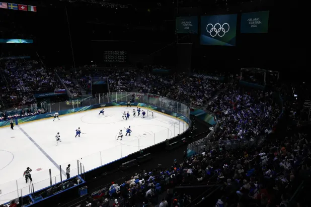 Finland players vie for the puck against Slovakia players during the Men's Preliminary Round match Slovakia against Finland of the Ice Hockey competitions, at the Milano Cortina 2026 Winter Olympic Games in Milano, Italy, 11 February 2026. (EPA)