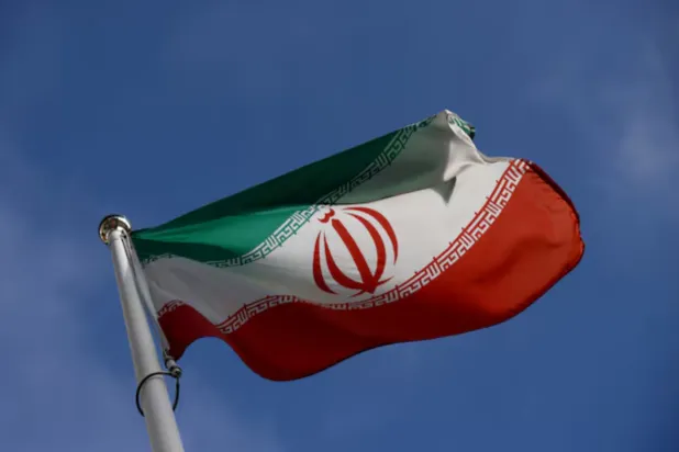 The Iranian flag waves in front of the International Atomic Energy Agency (IAEA) headquarters, before the beginning of a board of governors meeting, in Vienna, Austria, March 1, 2021. REUTERS/Lisi Niesner 
