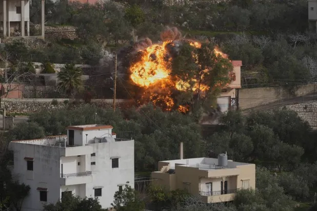  Flames rise from a building that was hit by an Israeli airstrike in Ain Qana village, south Lebanon, on Feb. 2, 2026. (AP) 