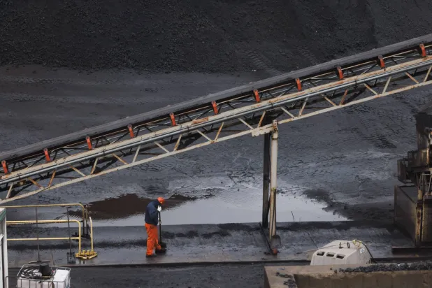 A worker in the coal fields at US Steel's Clairton Coke Works in Clairton, Pa., on Wednesday, Nov. 19, 2025. (Quinn Glabicki/Pittsburgh's Public Source via AP)