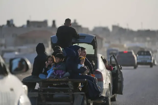 Gazze Şeridi’ndeki bir aracın arkasında seyahat eden Filistinliler (AP)