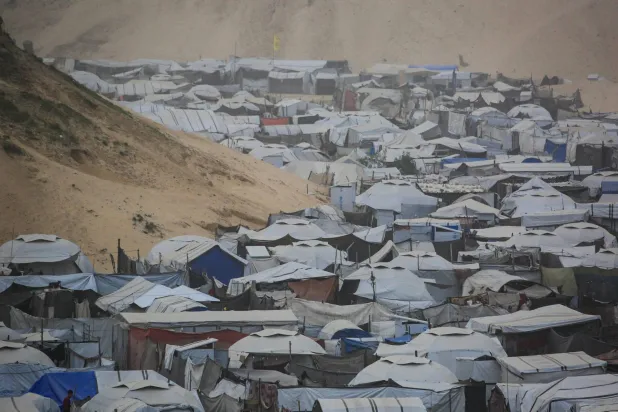 A photograph shows tents and makeshift shelters at a camp for displaced Palestinians in Khan Yunis, in the southern Gaza Strip, on a foggy day on February 14, 2026. (Photo by Bashar Taleb / AFP)