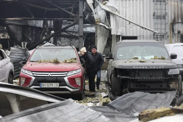 Ukrainian people survey the site of the overnight Russian attack on the residential area in Odesa, Ukraine, 13 February 2026. EPA/IGOR MASLOV
