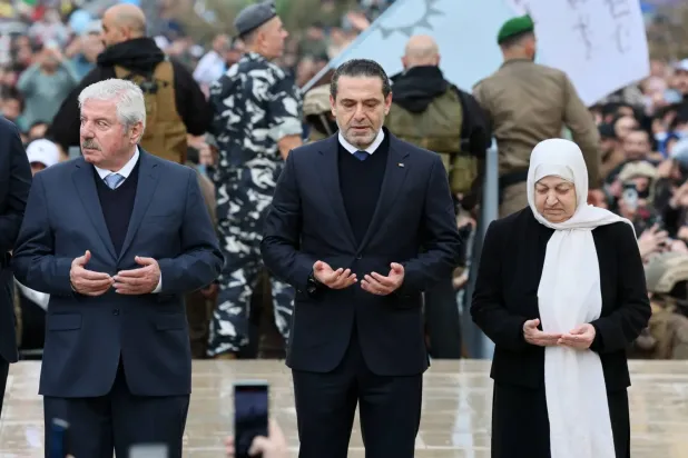 Saad Hariri, babası Refik Hariri’nin suikastının 21. yıldönümünde Beyrut'un merkezinde babasının mezarı başında, teyzesi eski Milletvekili Behiye ve amcası Şefik'in arasında dua ederken (EPA)