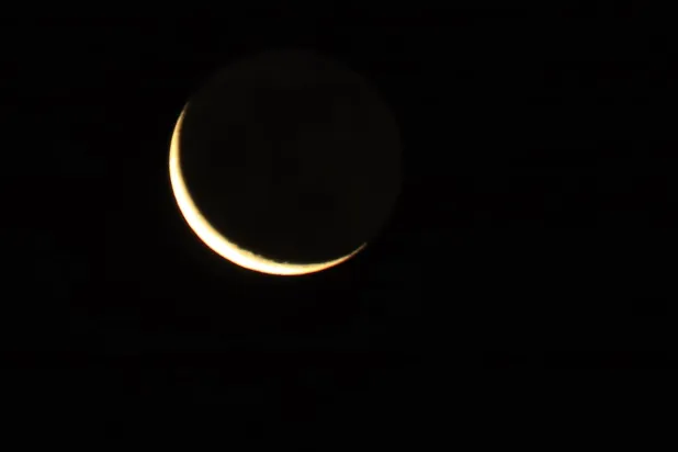 A waning crescent moon shines in the sky over Sanaa, Yemen, 15 February 2026, ahead of the holy fasting month of Ramadan. (EPA)