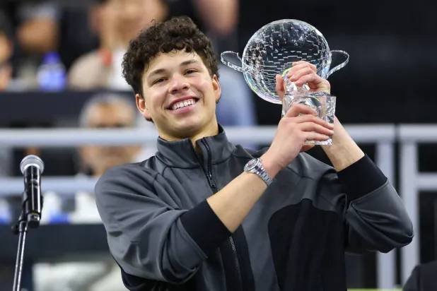 FRISCO, TEXAS - FEBRUARY 15: Ben Shelton of the United States holds the winner's trophy after defeating Taylor Fritz of the United States to win the Men's Singles competition at the 2026 Dallas Open at The Ford Center at The Star on February 15, 2026 in Frisco, Texas. Sam Hodde/Getty Images/AFP