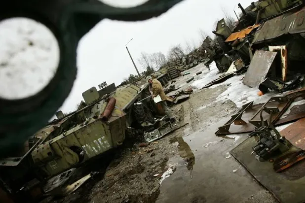 عامل يقيس مستويات الإشعاع في مقبرة بحثاً عن معدات ملوثة استخدمت خلال كارثة تشيرنوبل (رويترز)