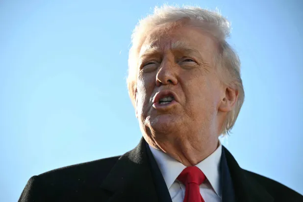 US President Donald Trump speaks to the press before boarding Air Force One at Pope Army Airfield at Fort Bragg, North Carolina on February 13, 2026, on his way to Palm Beach, Florida, to spend the weekend. (AFP)
