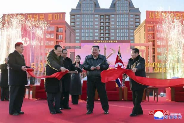 This picture taken on February 16, 2026 and released by North Korea's official Korean Central News Agency (KCNA) on February 17, 2026 shows North Korean leader Kim Jong Un (C) and his daughter Ju Ae (center L) attending the inauguration ceremony of 10,000 flats of the fourth stage in Hwasong Area of Pyongyang. (KCNA via KNS / AFP)