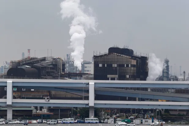 FILE - In this Oct. 21, 2013, file photo, smoke billows from an oil refinery in Kawasaki, southwest of Tokyo. (AP Photo/Koji Sasahara, File)