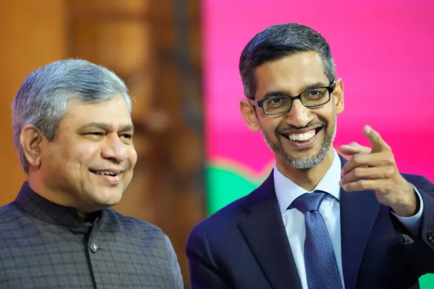 FILE -Google CEO Sundar Pichai, right, interacts with India's Minister for Information and Technology Ashwini Vaishnaw during Google for India 2022 event in New Delhi, Dec. 19, 2022. (AP Photo/Manish Swarup), File)