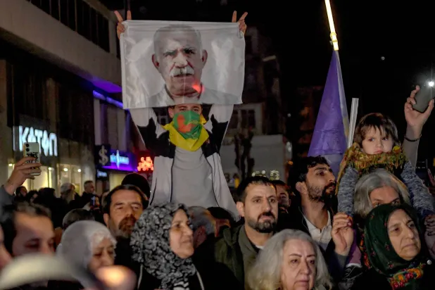 Members of the Kurdish community take part in a protest calling for the release of convicted Kurdistan Worker's Party (PKK) leader Abdullah Ocalan in Diyarbakir on February 15, 2026. (Photo by Ilyas AKENGIN / AFP)