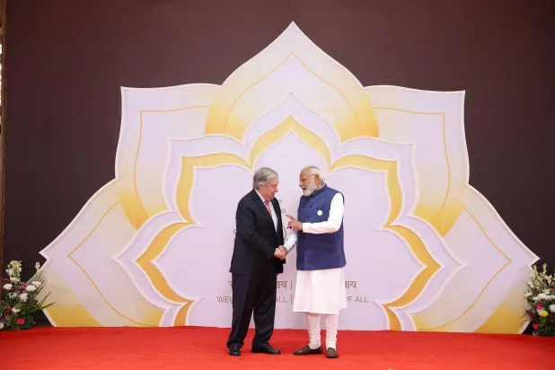 India's Prime Minister Narendra Modi speaks with United Nations Secretary-General Antonio Guterres during a welcoming ceremony at AI Impact Summit, in New Delhi, India, February 18, 2026. India's Press Information Bureau/Handout via REUTERS 