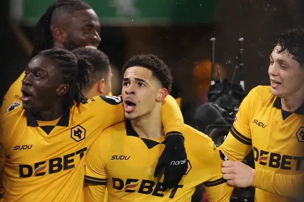 Soccer Football - Premier League - Wolverhampton Wanderers v Arsenal - Molineux Stadium, Wolverhampton, Britain - February 18, 2026  Wolverhampton Wanderers' Tom Edozie celebrates scoring their second goal with teammates REUTERS/Chris Radburn 
