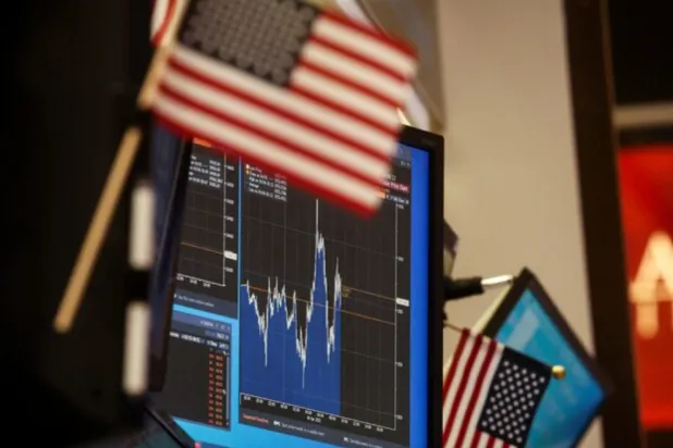 A screen displays a stock chart at a work station on the floor of the New York Stock Exchange (NYSE) in New York City, US, April 6, 2022. REUTERS/Brendan McDermid