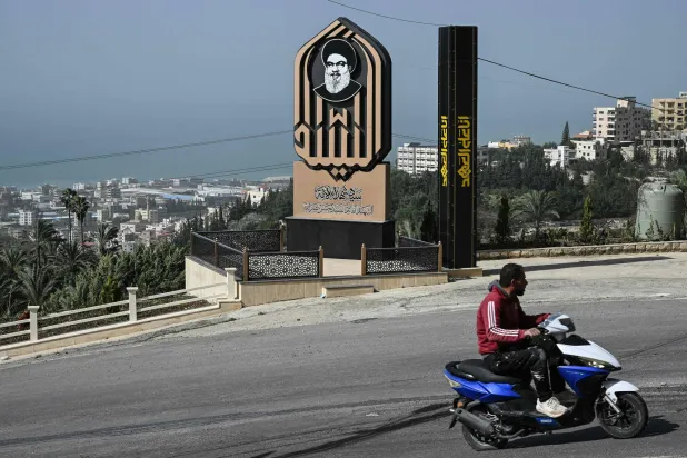 This photograph shows a memorial for slain Lebanese Hezbollah longtime leader Hassan Nasrallah at the entrance of the southern village of Qannarit on February 16, 2026. (AFP)