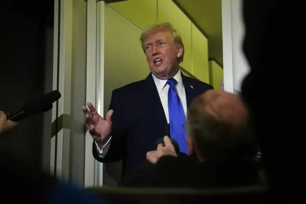 US President Donald Trump speaks aboard Air Force One (AP)