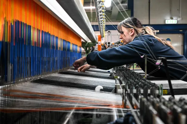 Members of staff work at the Alex Begg mill in Ayr, southwest Scotland, on January 15, 2026. (AFP)