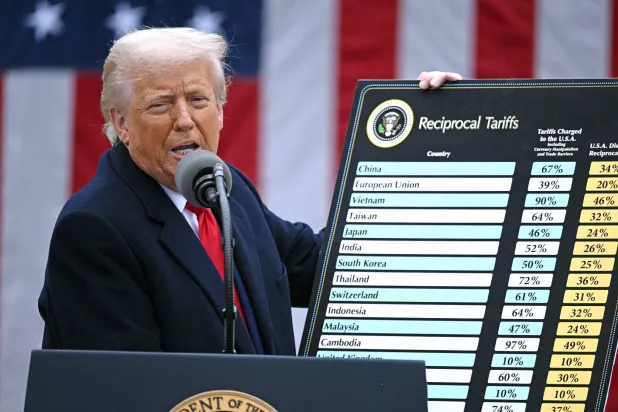 (FILES) US President Donald Trump holds a chart as he delivers remarks on reciprocal tariffs during an event in the Rose Garden entitled "Make America Wealthy Again" at the White House in Washington, DC, on April 2, 2025. (Photo by Brendan SMIALOWSKI / AFP)