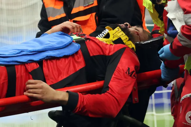 AC Milan's Ruben Loftus-Cheek is carried off the pitch injured during the Italian Serie A soccer match between Milan and Parma in Milan, Italy, 22 February 2026. EPA/MATTEO BAZZI