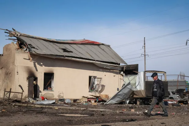 A resident walks at the site of the Russian drone strike, amid Russia's attack on Ukraine, near the city of Chornomorsk, Odesa region, Ukraine February 23, 2026. (Reuters)