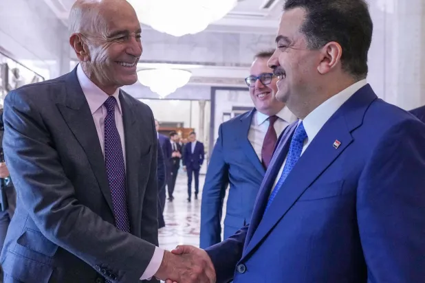 This handout picture made available by the Iraqi prime minister's office shows Iraq's Prime Minister Mohammed Shia al-Sudani (R) receiving US Special Envoy to Iraq Tom Barrack (L) before attending the signing of agreements between Chevron Corporation and the Basra, Dhi Qar, and North Oil Companies at the government palace in Baghdad on February 23, 2026. (Iraqi Prime Minister’s Press Office / AFP)  