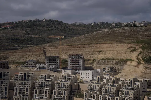 FILE - This photo shows a construction site of new housing projects in the West Bank Israeli settlement of Givat Ze'ev, Monday, June 18, 2023. (AP Photo/Ohad Zwigenberg, File)
