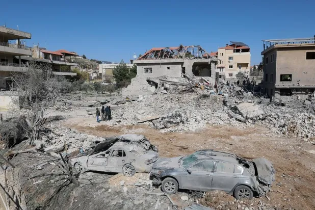 People gather near a building damaged in an Israeli strike in the village of Bednayel in eastern Lebanon, 21 February 2026. (EPA)