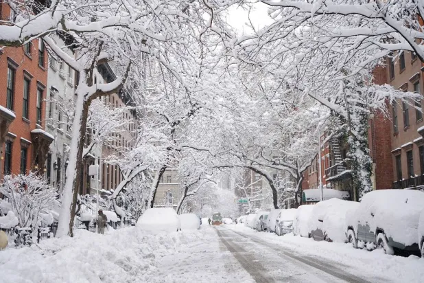 A snow plow crosses Second Avenue and heads down 19th Street to clear it after a snowstorm, Monday, Feb. 23, 2026, in New York. (AP)