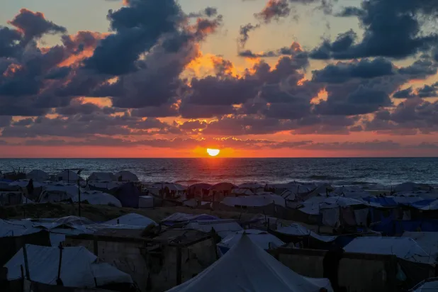 Tents of displaced Palestinian families at sunset as they prepare to break their fast during the holy month of Ramadan, near the beach in Gaza City, 24 February 2026. (EPA)