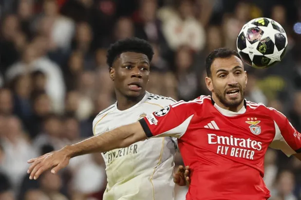 Real Madrid's Aurelien Tchouameni (L) and Benfica's Vangelis Pavlidis fight for the ball during the UEFA Champions League play-offs second leg soccer match between Real Madrid and Benfica in Madrid, Spain, 25 February 2026.  EPA/Sergio Perez