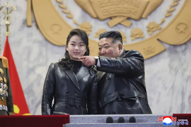 This picture taken on February 25, 2026 and released by North Korea's official Korean Central News Agency (KCNA) on February 26, 2026 shows North Korean leader Kim Jong Un (R) and his daughter Kim Ju Ae attending the military parade to commemorate the 9th Congress of the Workers' Party of Korea at Kim Il-sung Square in Pyongyang. (Photo by KCNA VIA KNS / AFP) 