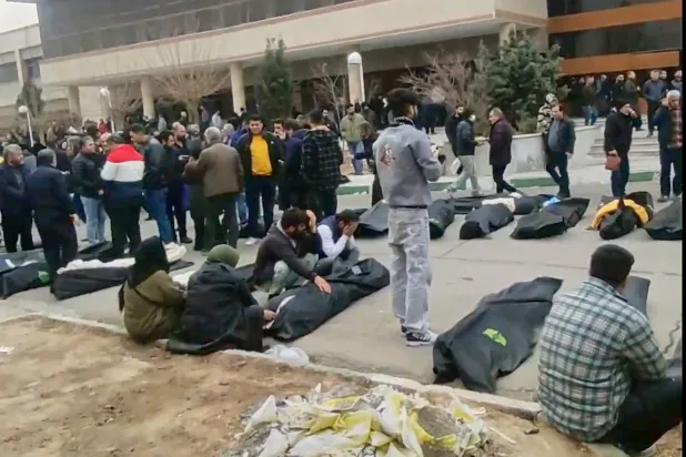 This image from video taken between Jan. 9 and Jan. 11, 2026, and verified by AP, shows bodies and mourners outside a morgue in Iran, following a crackdown on protests in Kahrizak, Tehran province. (UGC via AP, File) 