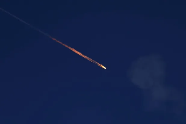 A fragment falls through the sky after Israel's Iron Dome intercepted a missile launched from Iran towards Israel, amid the Iran-Israel conflict, as seen from Ashkelon, Israel June 20, 2025. (Reuters)