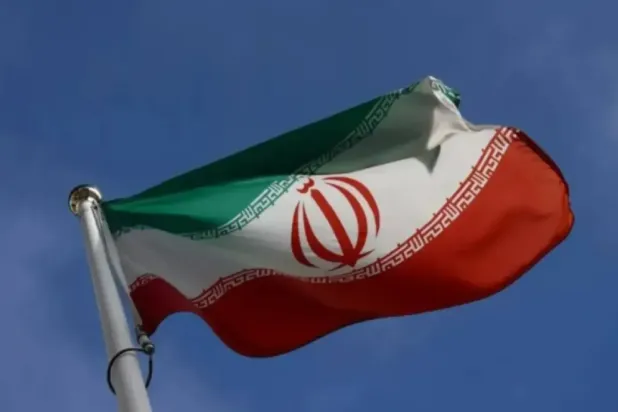 The Iranian flag waves in front of the International Atomic Energy Agency (IAEA) headquarters, before the beginning of a board of governors meeting, amid the coronavirus disease (COVID-19) outbreak in Vienna, Austria, March 1, 2021. (Reuters)
