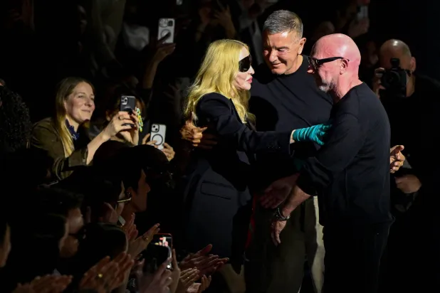 US singer Madonna (L) is welcomed by Italian stylists Domenico Dolce (R) and Stefano Gabbana (C) after the womens's ready-to-wear Fall/Winter 2026 collection fashion show as part of the Milan Fashion Week, in Milan on February 28, 2026. (Photo by Miguel MEDINA / AFP)