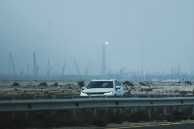  A car passes near QatarEnergy's liquefied natural gas (LNG) production facilities, amid the US-Israeli conflict with Iran, in Ras Laffan Industrial City, Qatar March 2, 2026. (Reuters)