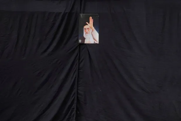  A picture of the late Iranian Supreme Leader Ali Khamenei hangs on a black sheet along the side of a mosque in Tehran, Iran, Monday, March 2, 2026. (AP) 
