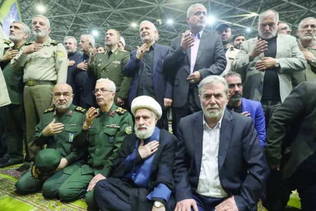 Islamic Jihad leader Ziad al-Nakhalah (R) sits beside Hezbollah Secretary-General Naim Qassem and senior Iranian military officials during the funeral of late Hamas leader Ismail Haniyeh in Tehran in August 2024. (Reuters) 