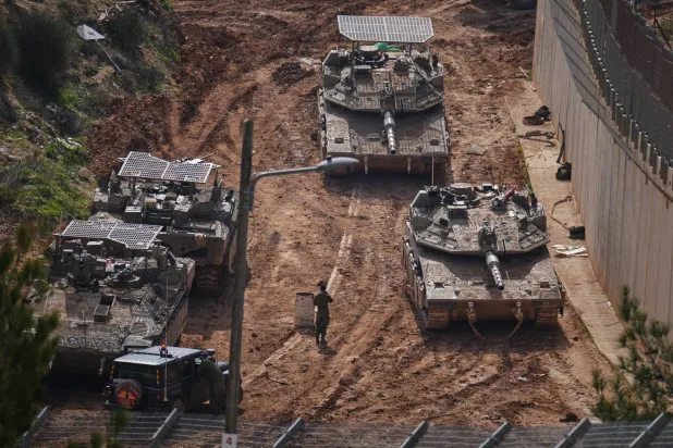 Israeli tanks maneuver near the Israel-Lebanon border, in northern Israel, Wednesday, March 4, 2026. (AP Photo/Ariel Schalit)