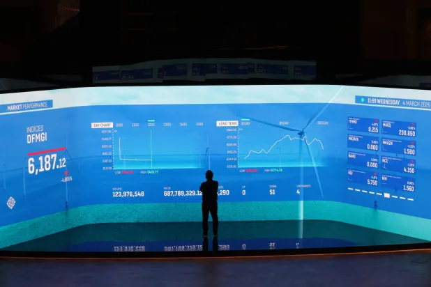 A man follows the stock market shares on a screen with stock information at the Dubai Financial Market (DFM) in the Gulf emirate of Dubai, United Arab Emirates, 04 March 2026. EPA/ALI HAIDER
