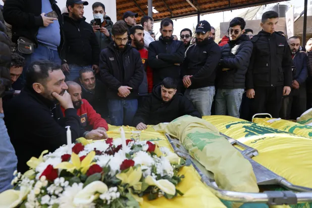Mourners gather around the Hezbollah-draped coffins of people killed in Israeli airstrikes on Baalbek, during their funeral in the city of Baalbek, in Bekaa valley, Lebanon, 05 March 2026. EPA/WAEL HAMZEH