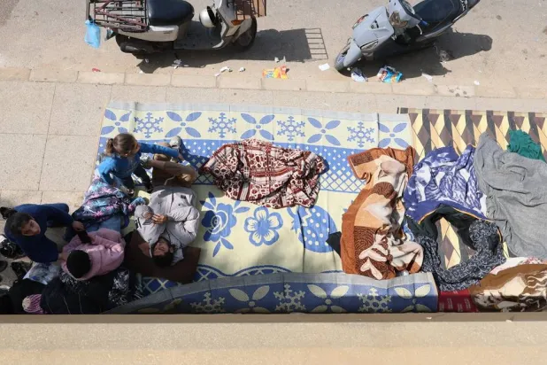 Displaced residents who fled Israeli airstrikes in Beirut's southern suburbs sit on the floor at the corniche waterfront in Beirut, Lebanon, 06 March 2026. (EPA)