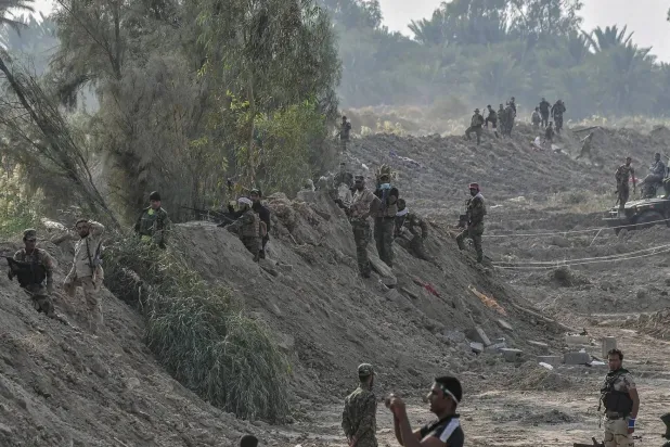 A photo released by the Popular Mobilization Forces showing its fighters in the town of Jurf al-Sakhar, south of Baghdad, in 2014 