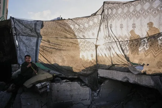  Obaida Suleiman, 8, sits on the ruins of a mosque where his family is currently taking shelter, after it was destroyed during the war between Israel and Hamas, in Deir al-Balah, Gaza Strip, Friday, March 6, 2026. (AP) 