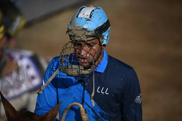 A cowboy gestures during a bull-tailing competition held as part of the "Fiestas del Alma Llanera" celebration in San Fernando de Apure, Apure State, Venezuela, on February 27, 2026. (AFP)