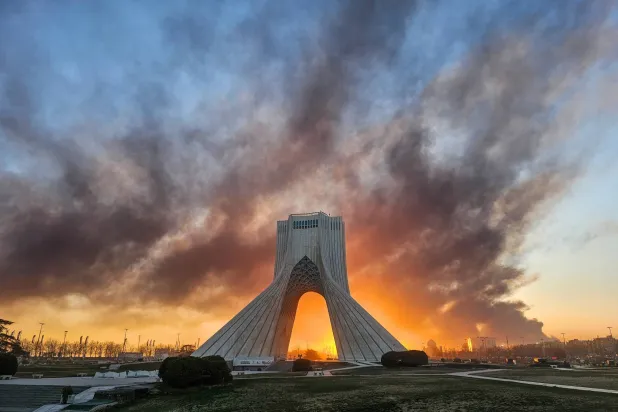 FILE - Smoke rises behind the Azadi (Freedom) monument in Tehran, Iran, on March 3, 2026, following the US-Israeli military attack. (Davoud Ghahrdar/ISNA via AP, File)