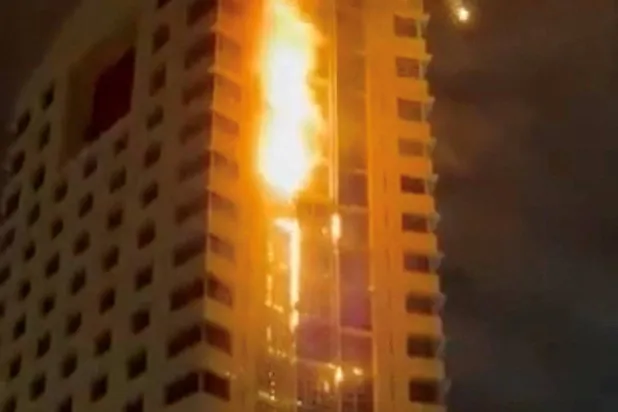 Smoke rises from a building on fire, in the aftermath of what the Kuwaiti Army says is a drone attack, amid the US-Israeli conflict with Iran, in Kuwait City, Kuwait March 8, 2026 in this screengrab taken from a social media video. SOCIAL MEDIA/via REUTERS 