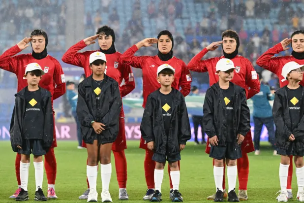 Iran players react during their national anthem ahead of the Women's Asian Cup soccer match between Iran and the Philippines in Robina, Australia, Sunday, March 8, 2026. (Dave Hunt/AAP Image via AP)